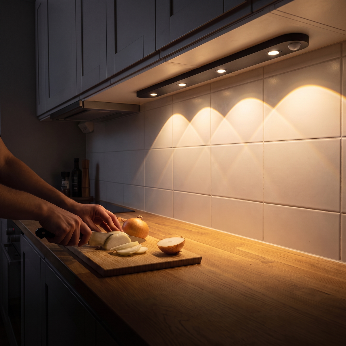 Hands chopping an onion on a kitchen worktop in their own shadow, while Lyra lights up the worktop further along